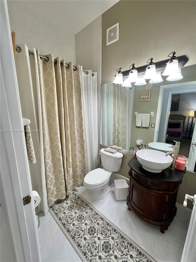 bathroom featuring tile floors, toilet, and vanity