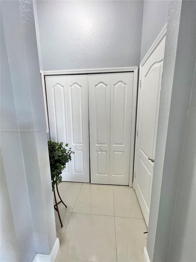 hall with light tile flooring