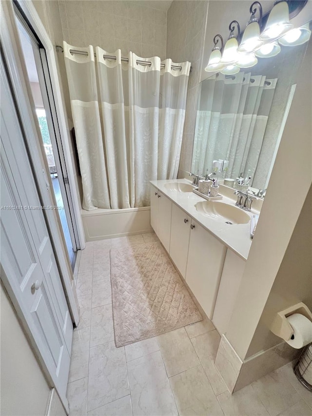 bathroom with tile floors, double sink, and oversized vanity