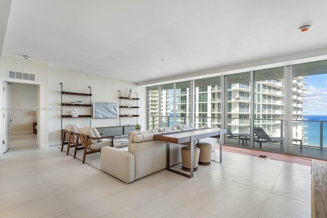 living room with a water view and a wall of windows