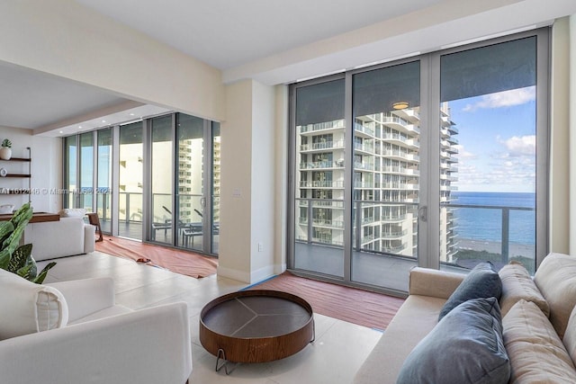 living room with expansive windows and a water view