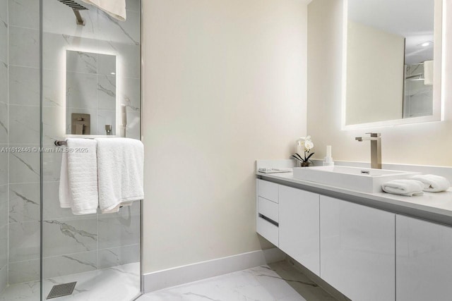 bathroom featuring a tile shower and vanity