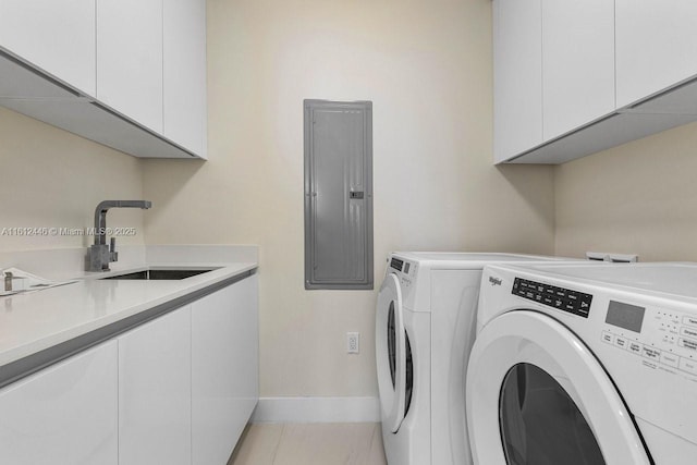 clothes washing area featuring cabinets, electric panel, sink, washer and dryer, and light tile patterned flooring