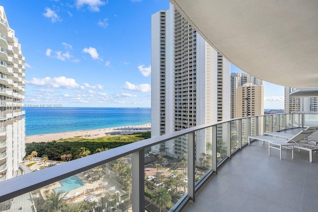 balcony with a water view and a beach view