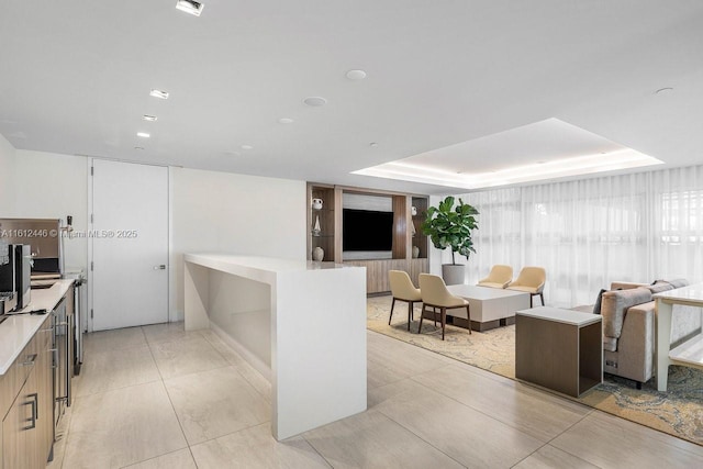 kitchen featuring a raised ceiling