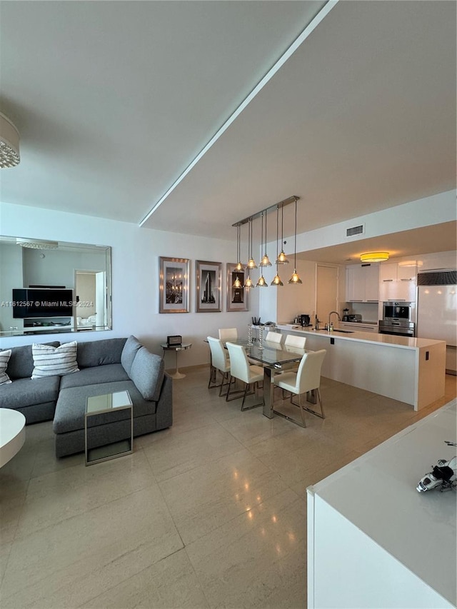 living area featuring visible vents and light tile patterned floors
