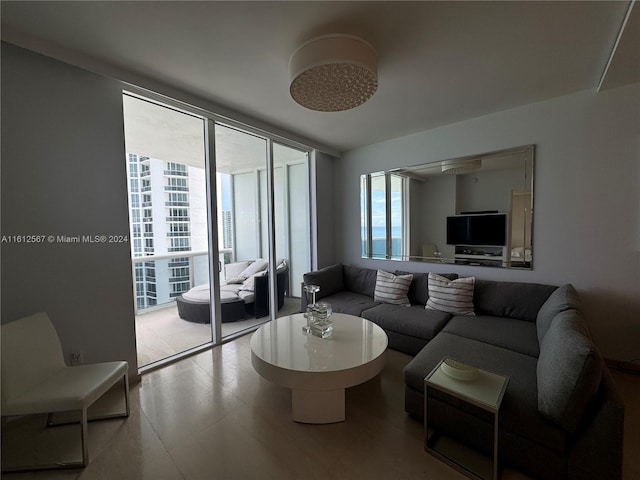 living room featuring floor to ceiling windows and tile flooring