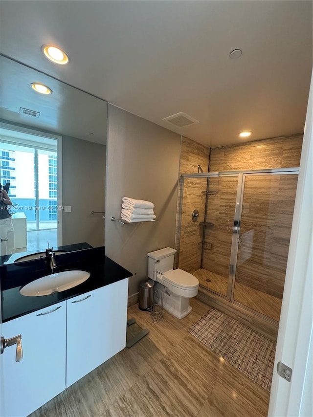bathroom featuring toilet, visible vents, a shower stall, and recessed lighting
