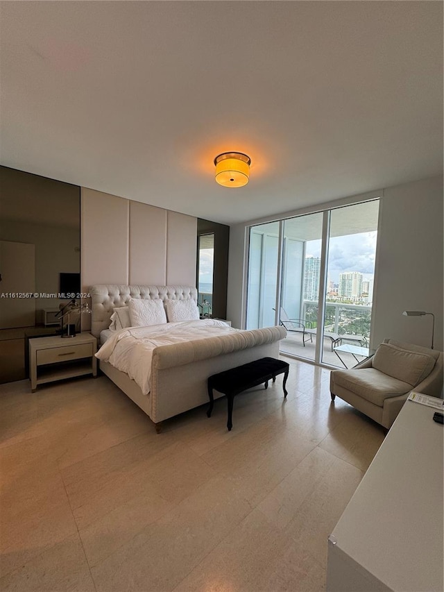 bedroom featuring access to outside and a wall of windows