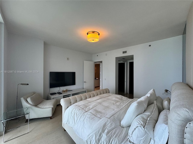 bedroom featuring visible vents and light carpet
