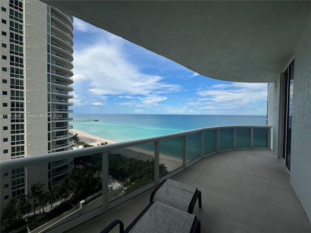 balcony with a view of the beach and a water view