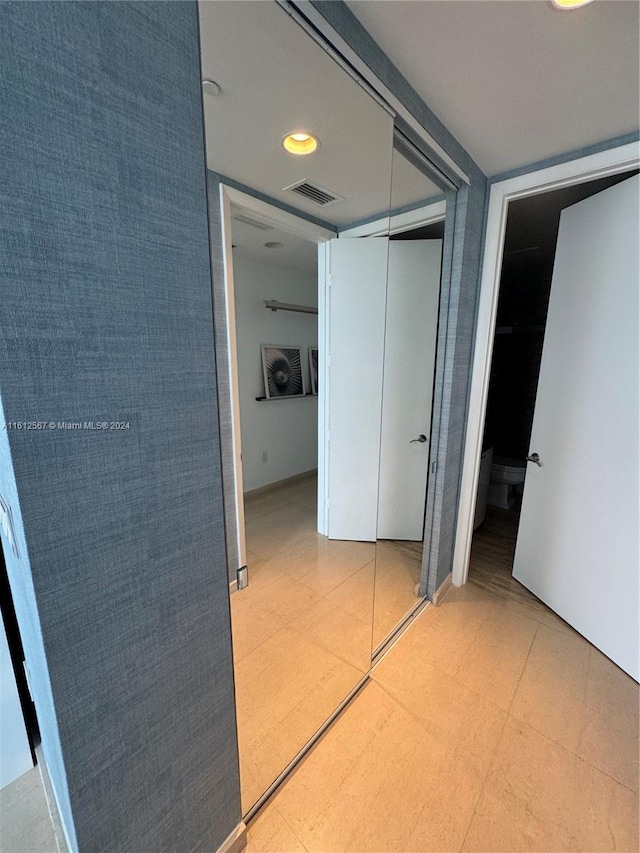 hallway featuring light tile floors