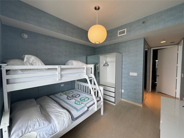 bedroom with visible vents and wallpapered walls