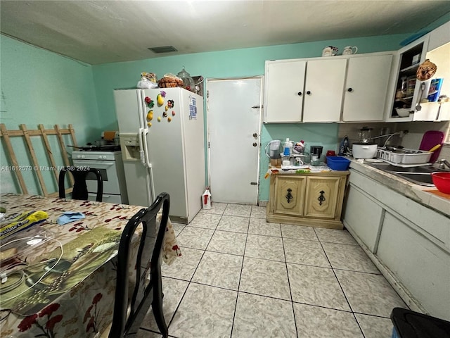 kitchen featuring white cabinetry, white appliances, and sink