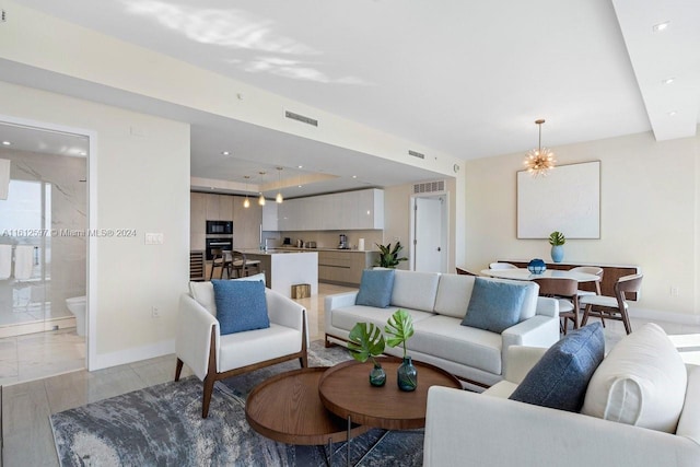 living room with a chandelier and light hardwood / wood-style floors