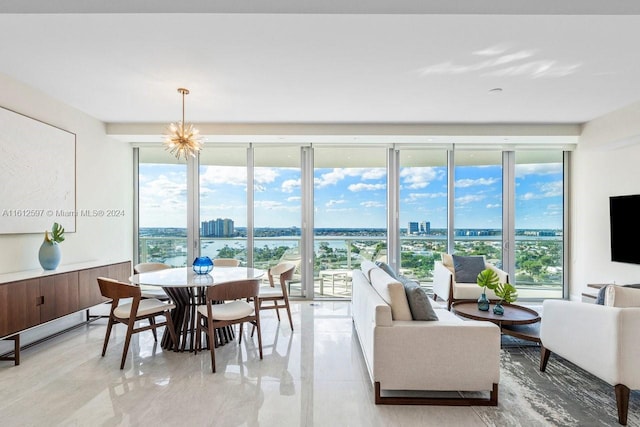 living room featuring floor to ceiling windows and a chandelier