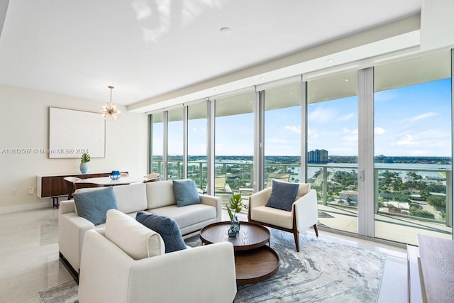 living room featuring a wall of windows, an inviting chandelier, and plenty of natural light