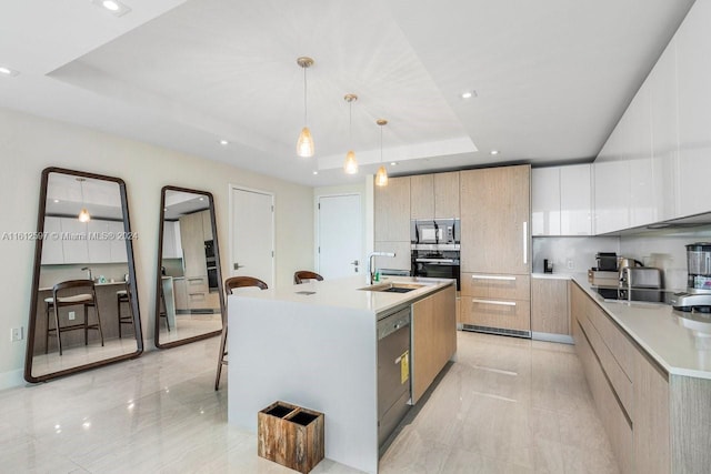 kitchen with black appliances, a raised ceiling, white cabinetry, and a kitchen island with sink