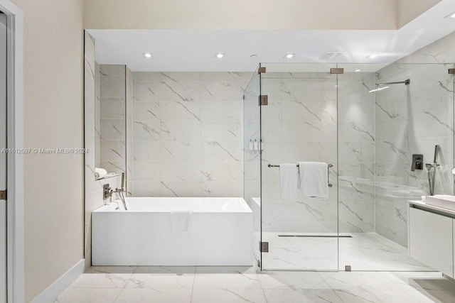 bathroom featuring vanity and separate shower and tub