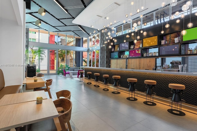 bar with a high ceiling and floor to ceiling windows