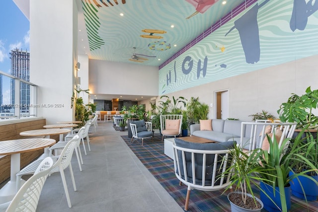 view of patio with an outdoor living space and ceiling fan