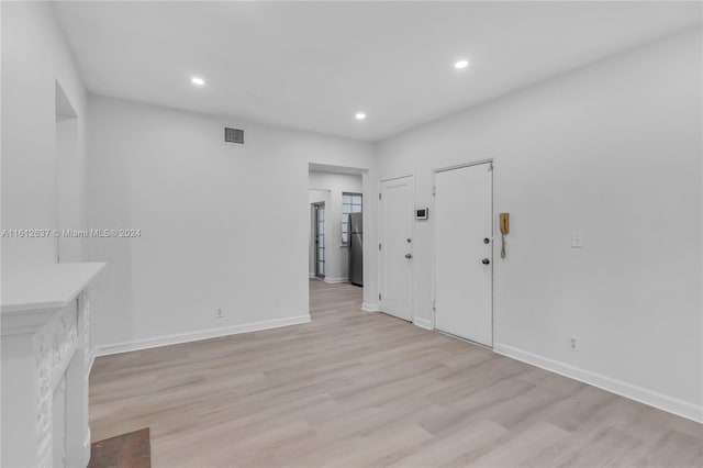 empty room with light hardwood / wood-style floors