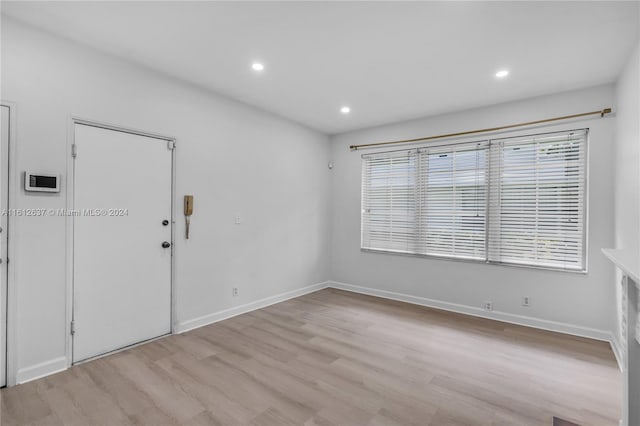 spare room featuring light wood-type flooring