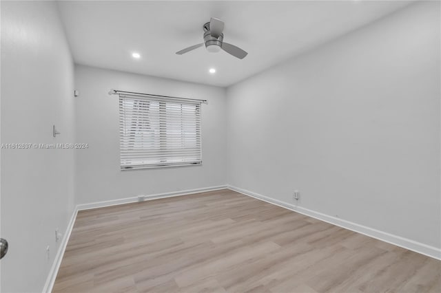 spare room featuring ceiling fan and light hardwood / wood-style floors