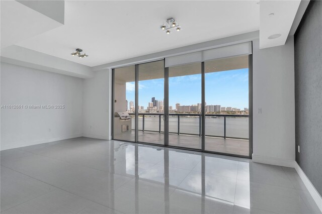 tiled empty room with a wall of windows