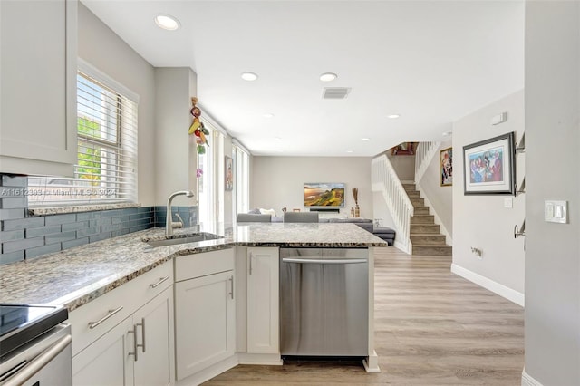 kitchen featuring light hardwood / wood-style floors, sink, white cabinetry, and dishwasher