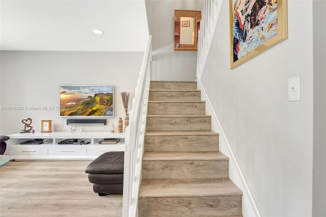 stairway with hardwood / wood-style flooring