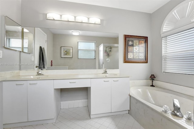 bathroom featuring dual vanity, tile flooring, and a bathtub