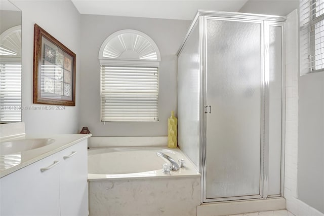 bathroom featuring tile floors, plus walk in shower, and vanity