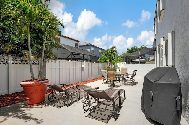 view of patio with a lanai and area for grilling