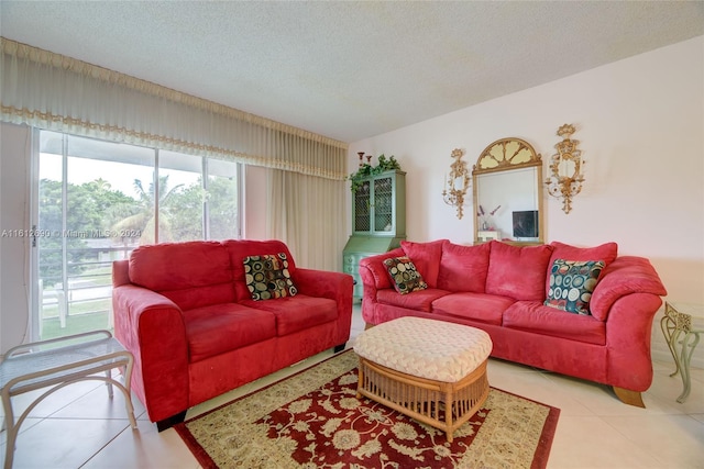 living room featuring a healthy amount of sunlight, tile flooring, and a textured ceiling