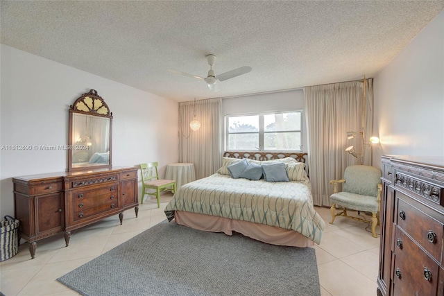 tiled bedroom with ceiling fan and a textured ceiling