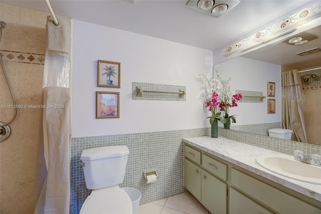 bathroom featuring tile flooring, tasteful backsplash, tile walls, toilet, and large vanity