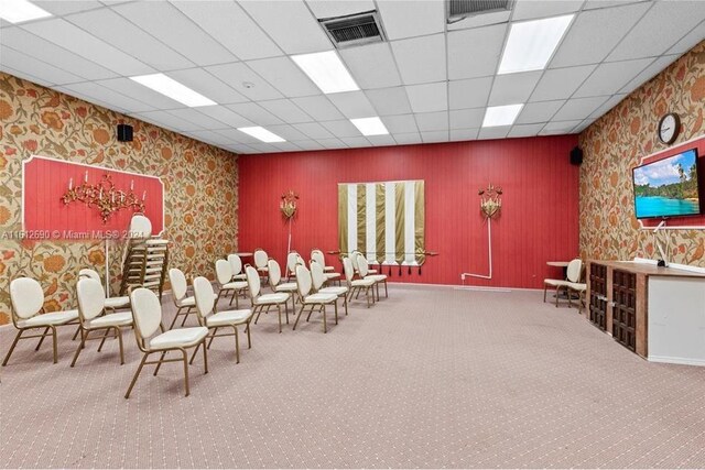 misc room with carpet flooring and a paneled ceiling