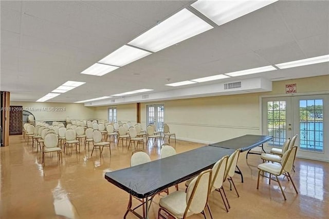 dining space featuring a paneled ceiling and french doors