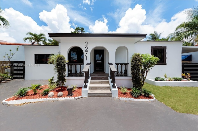 mediterranean / spanish house with a porch