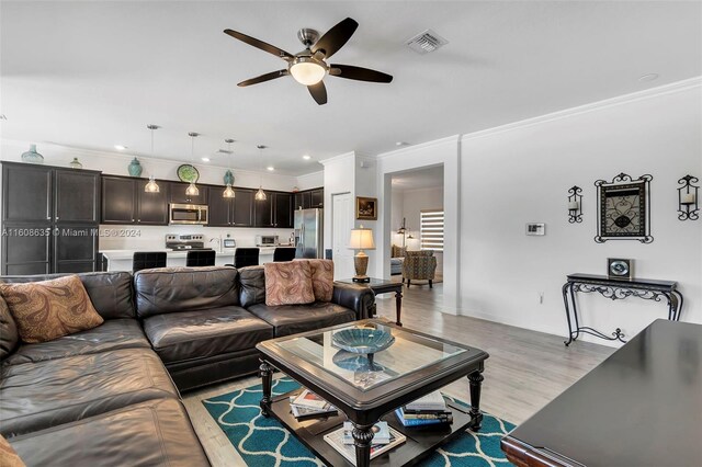 living room with ceiling fan, light hardwood / wood-style flooring, and ornamental molding