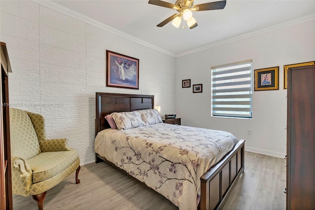 bedroom featuring hardwood / wood-style floors, ceiling fan, and crown molding