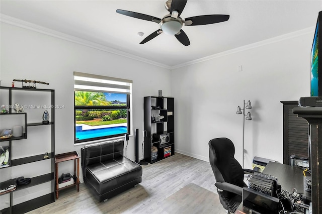 office with light wood finished floors, baseboards, a ceiling fan, and crown molding