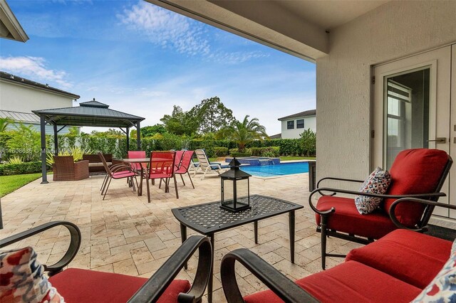 view of patio / terrace featuring a gazebo and a fenced in pool