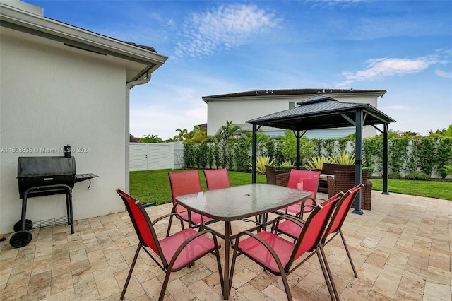 view of patio / terrace with grilling area, outdoor dining area, a fenced backyard, and a gazebo