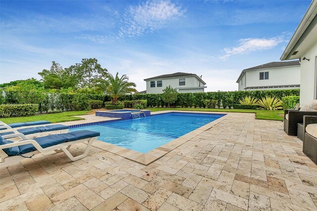 view of swimming pool featuring a patio and an in ground hot tub