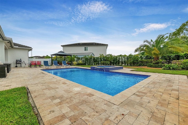 view of pool with a patio, an in ground hot tub, and a gazebo