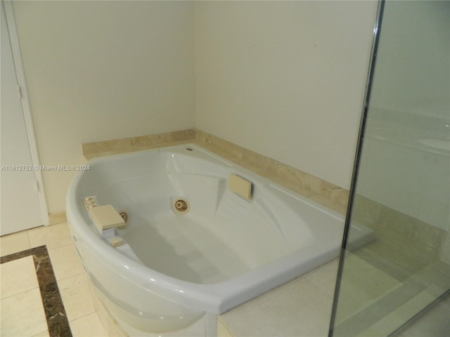 bathroom with tile patterned flooring and a bathtub