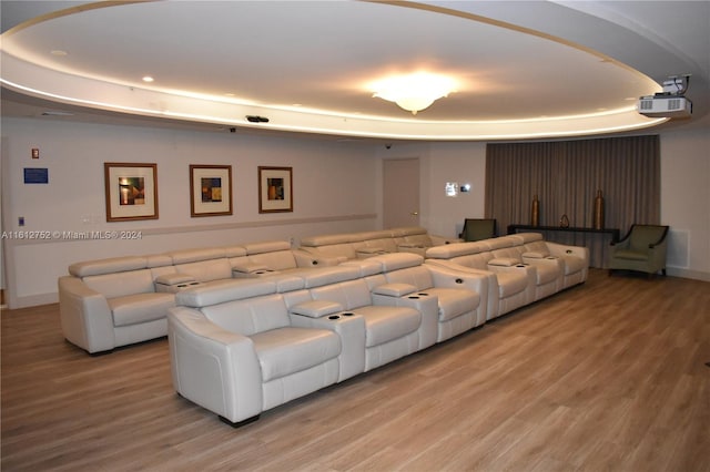 living room featuring hardwood / wood-style floors and a tray ceiling