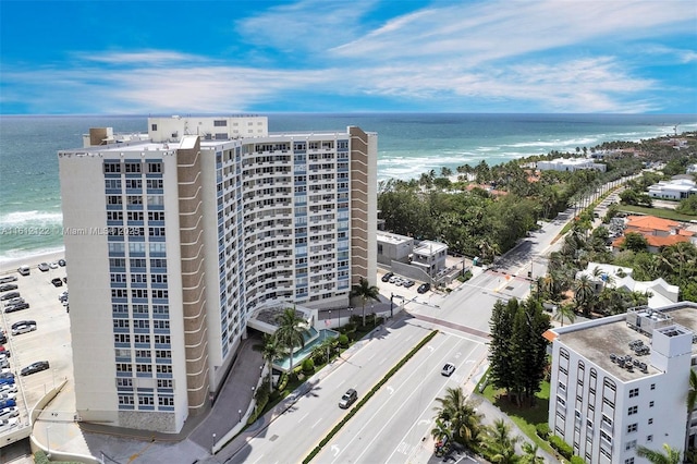 birds eye view of property with a water view and a view of the beach